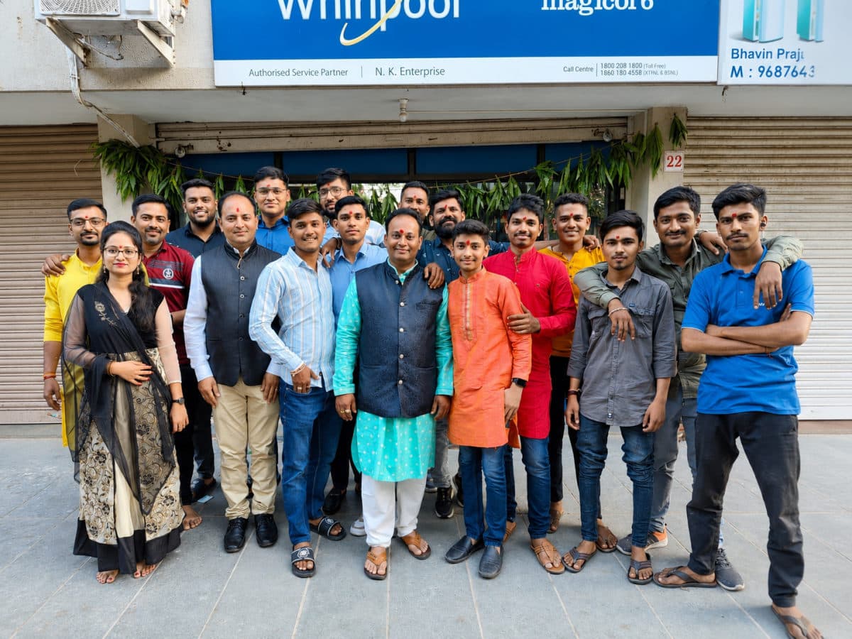 The NK Enterprise team outside their authorized Whirlpool service center in Ahmedabad